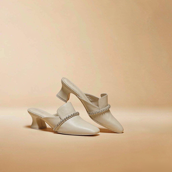 Nyla Embellished Mules ivory leather mules with a crystal-trimmed vamp